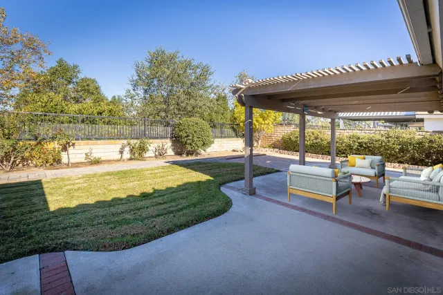 a view of a swimming pool with an outdoor space and seating area