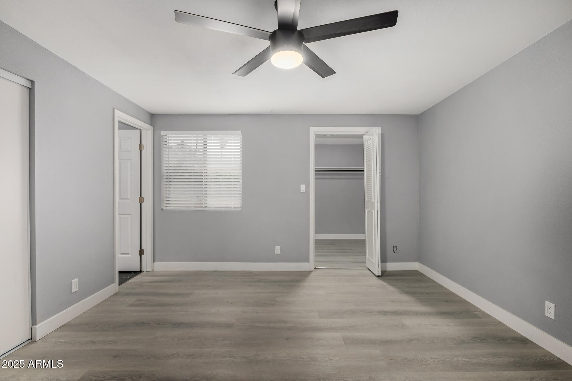 3619 West Griswold Road Phoenix, AZ 85051 - Photo 17 of 36 wooden floor in an empty room with a window