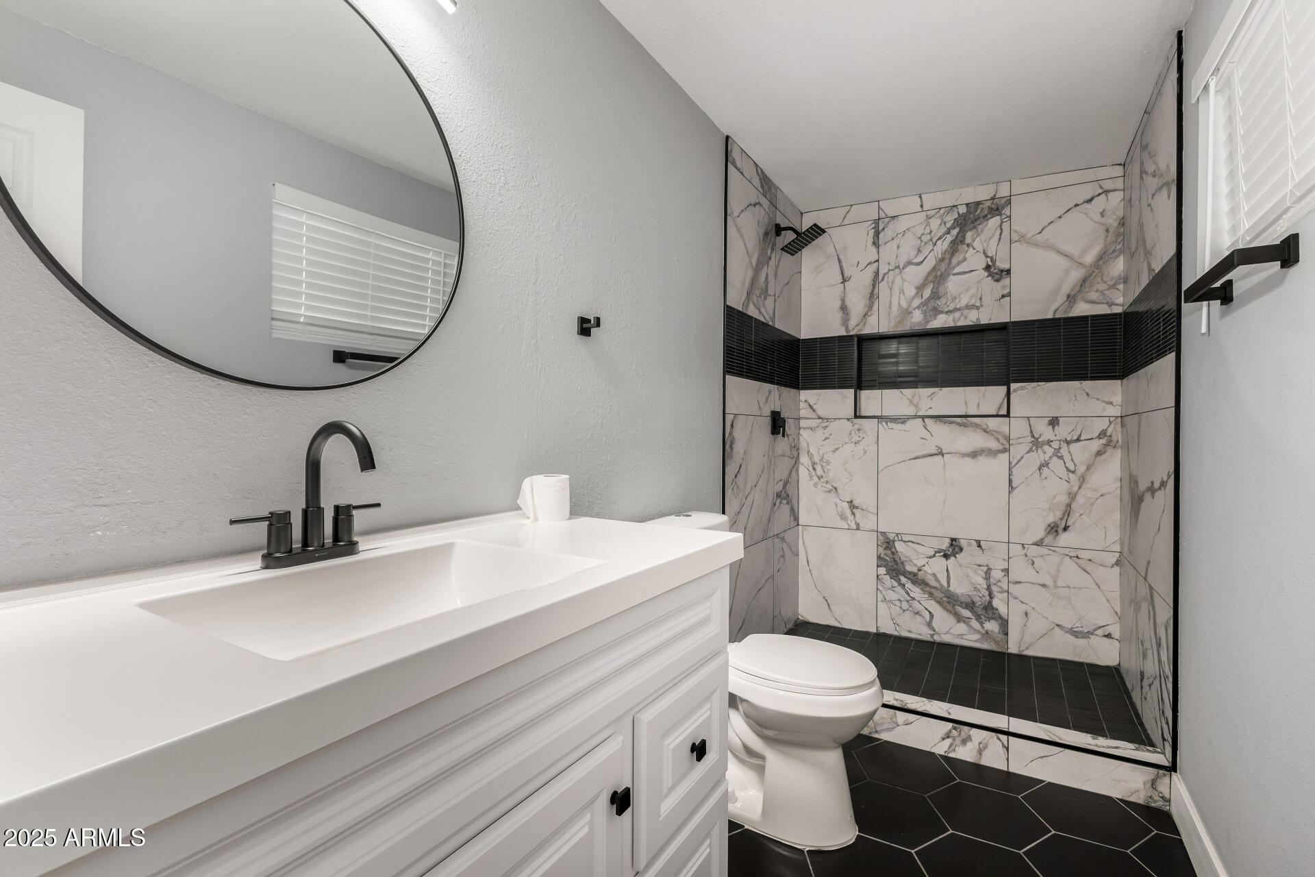 3619 West Griswold Road Phoenix, AZ 85051 - Photo 19 of 36 a bathroom with a sink toilet and shower