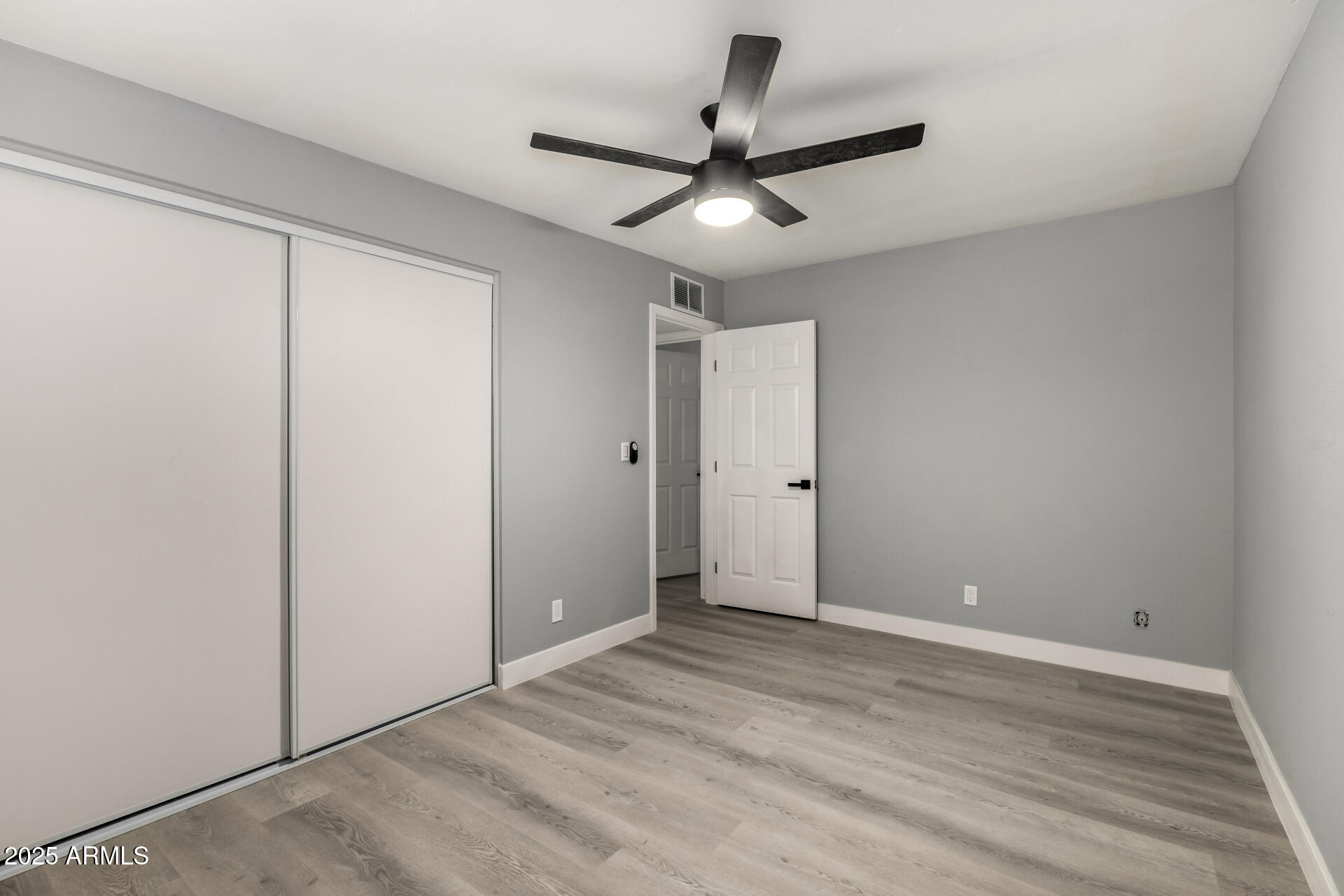 3619 West Griswold Road Phoenix, AZ 85051 - Photo 22 of 36 a view of a livingroom with a ceiling fan & hardwood floor