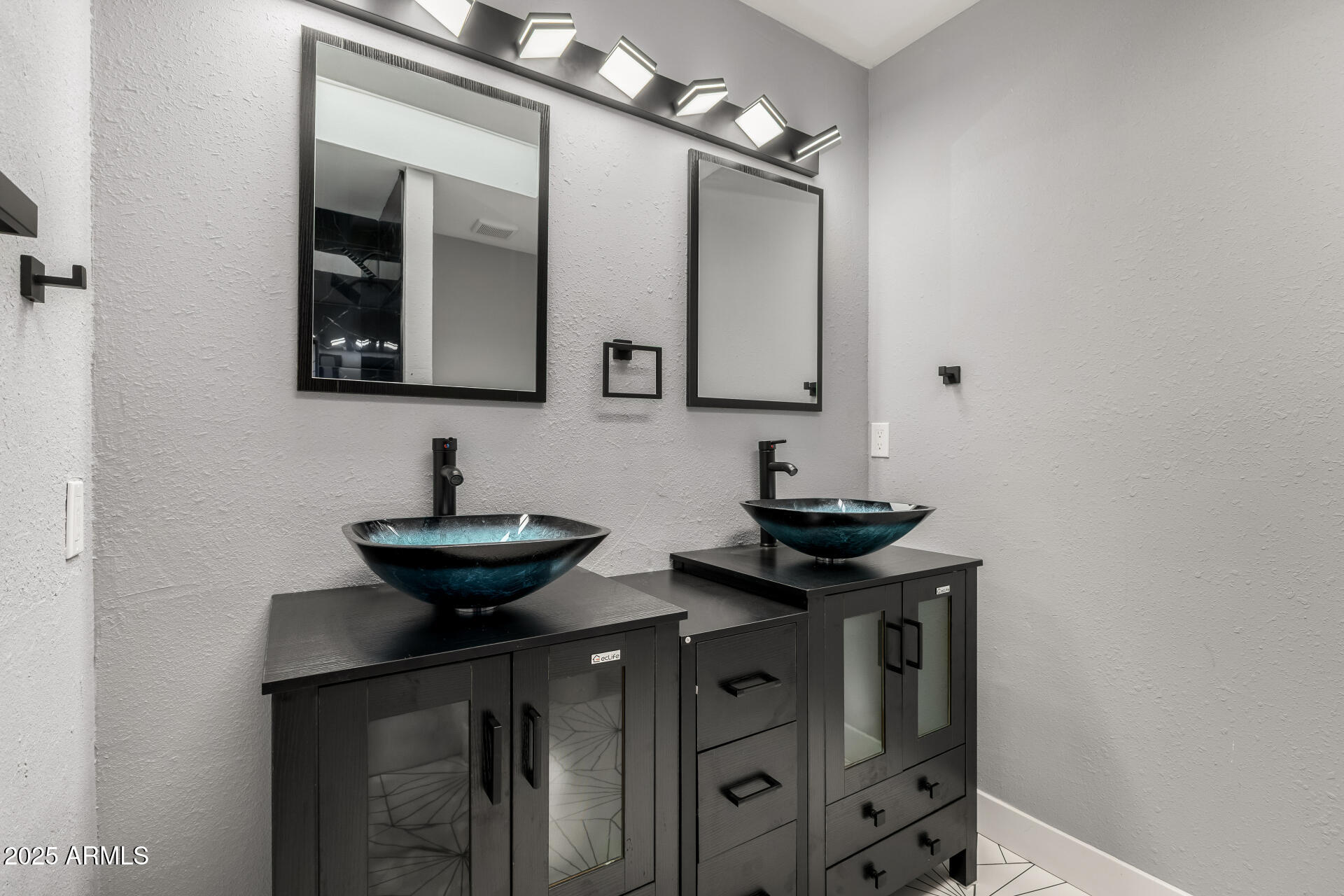 3619 West Griswold Road Phoenix, AZ 85051 - Photo 23 of 36 a bathroom with a sink and a mirror