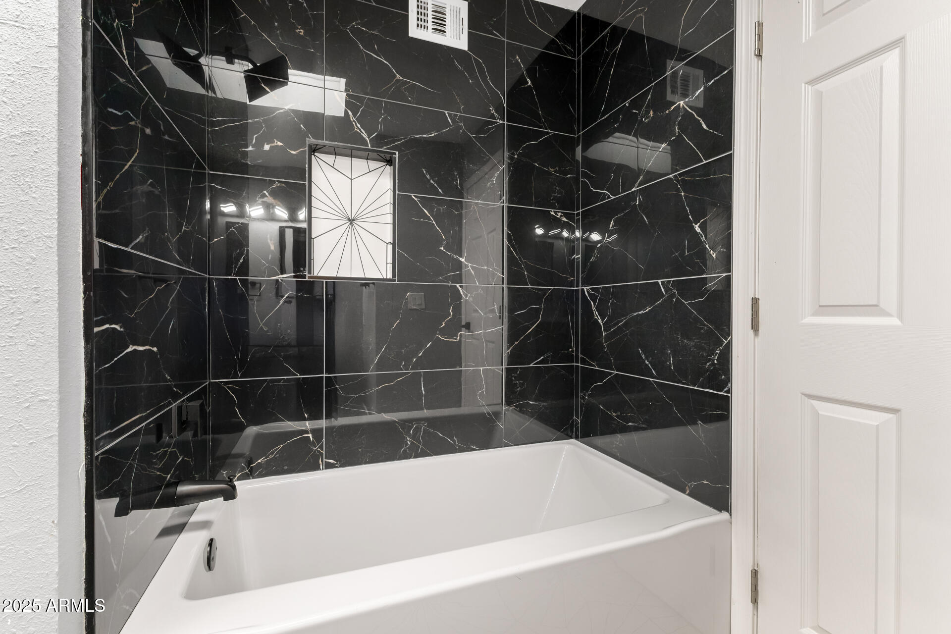 3619 West Griswold Road Phoenix, AZ 85051 - Photo 24 of 36 a bathroom with a bathtub and a shower
