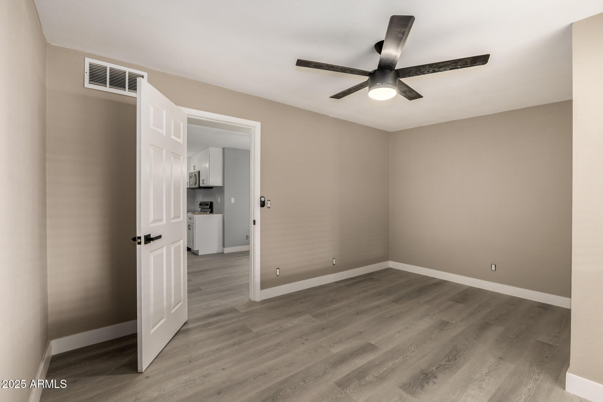 3619 West Griswold Road Phoenix, AZ 85051 - Photo 28 of 36 wooden floor in an empty room