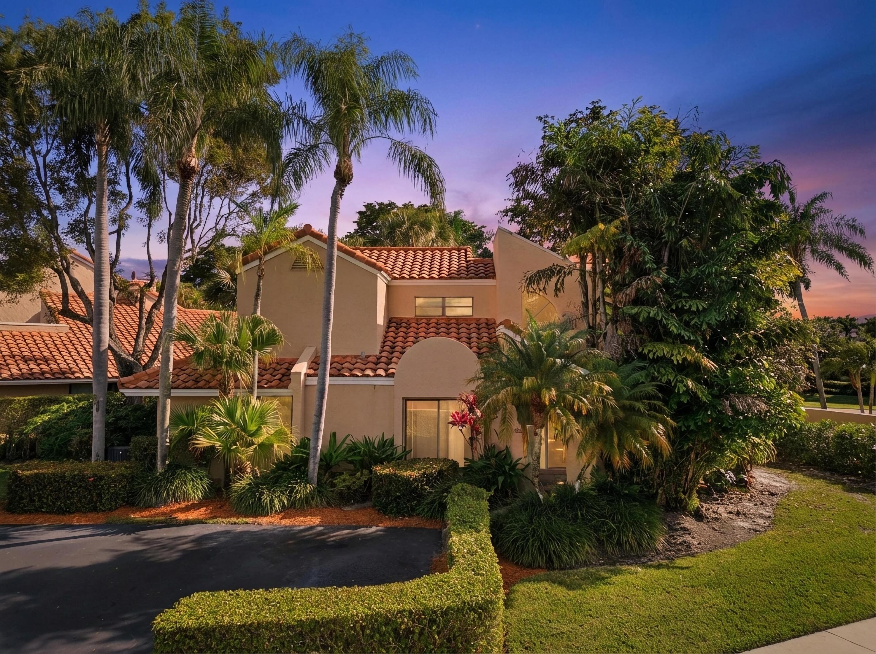 22511 Meridiana Drive Boca Raton, FL 33433 - Photo 11 of 40 a front view of a house with a yard