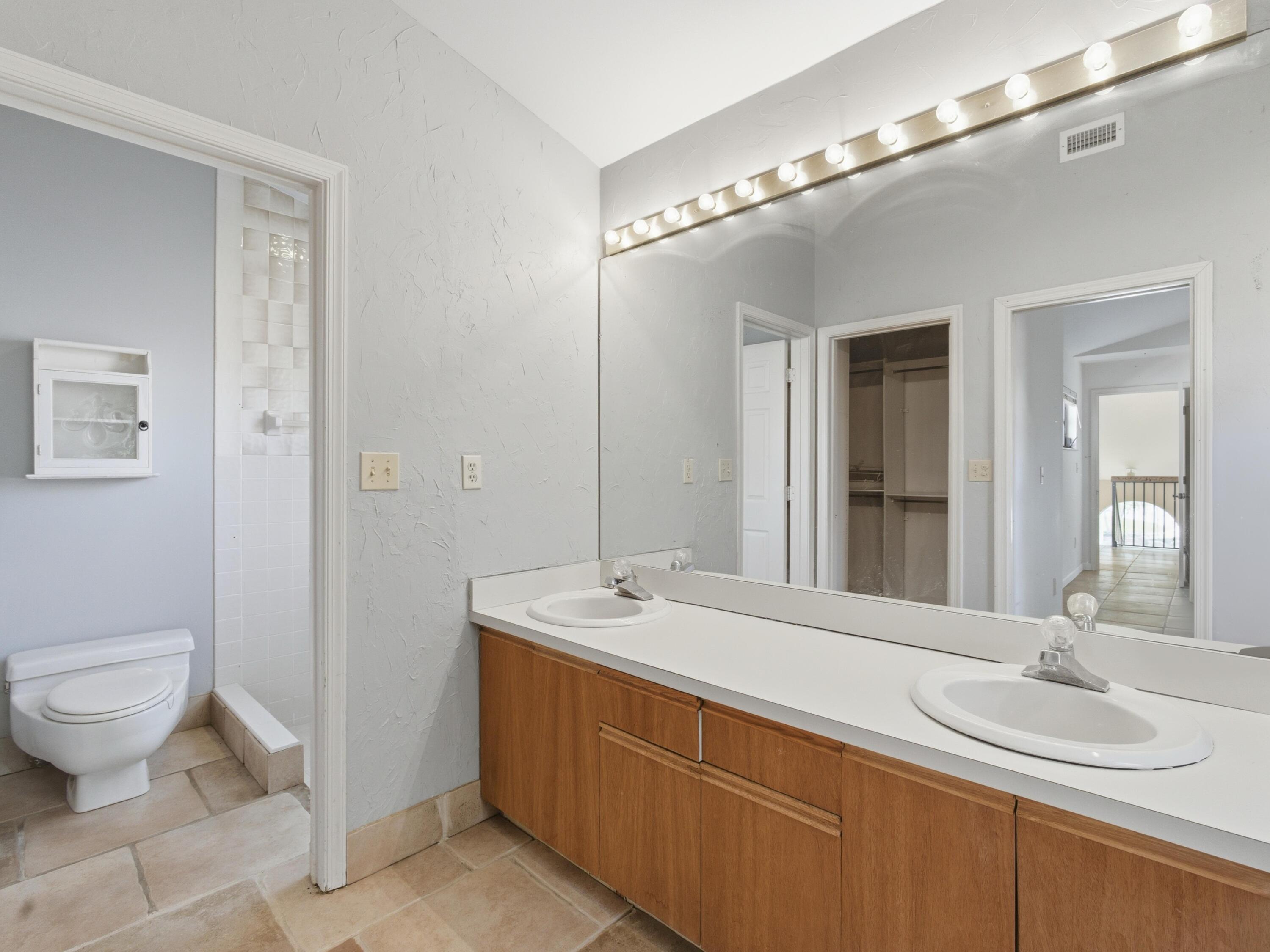 22511 Meridiana Drive Boca Raton, FL 33433 - Photo 27 of 40 a spacious bathroom with a granite countertop sink a toilet and a mirror