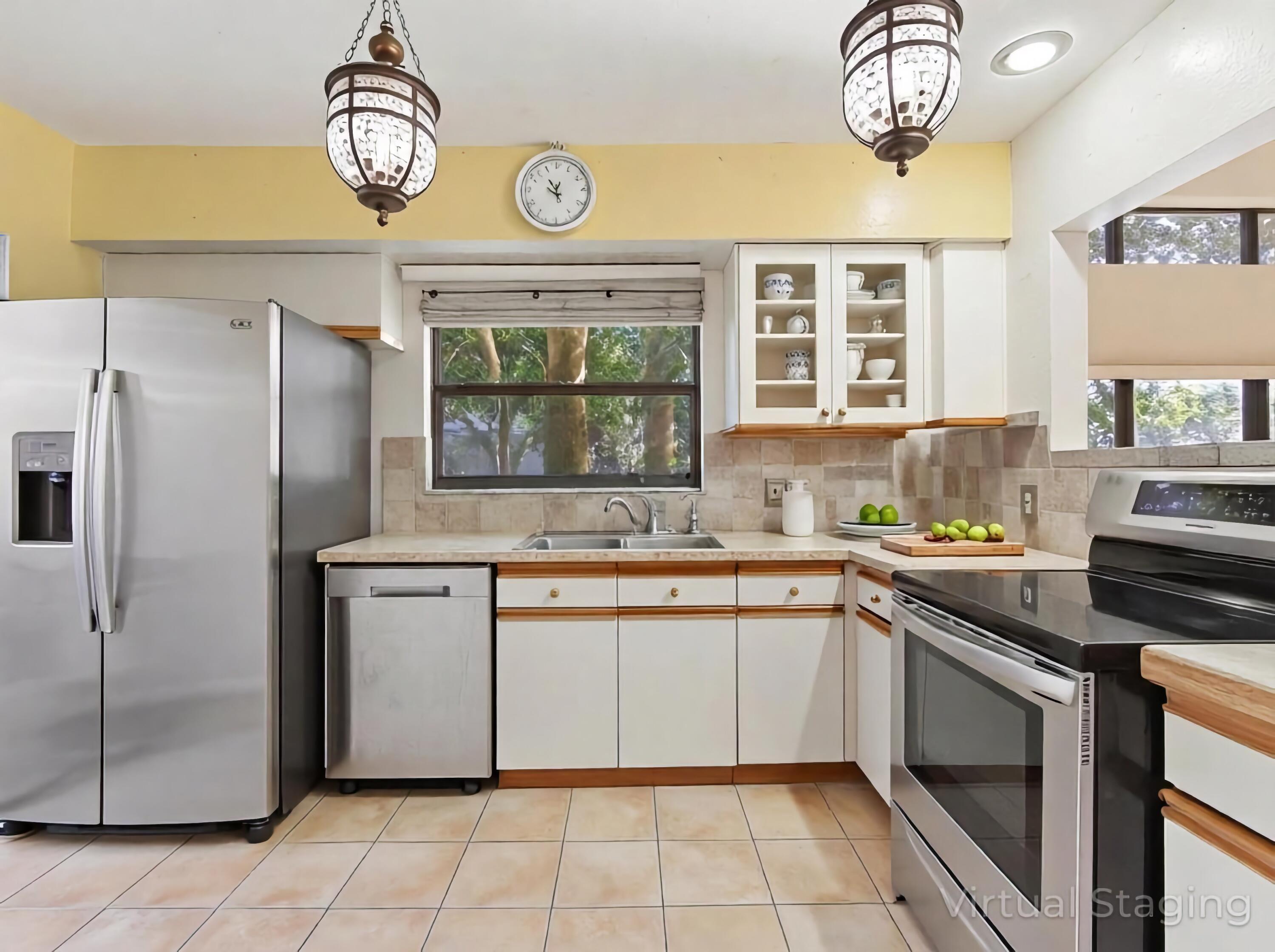22511 Meridiana Drive Boca Raton, FL 33433 - Photo 34 of 40 a kitchen with stainless steel appliances granite countertop a stove and a sink
