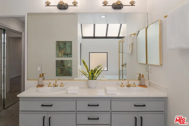 a bathroom with a sink double vanity and a mirror