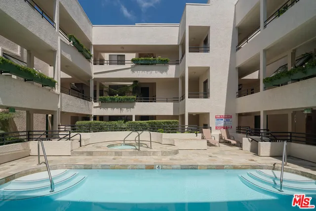 a view of a house with potted plants