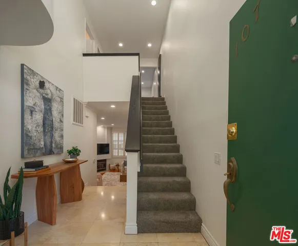 a view of entryway and hall with a front door