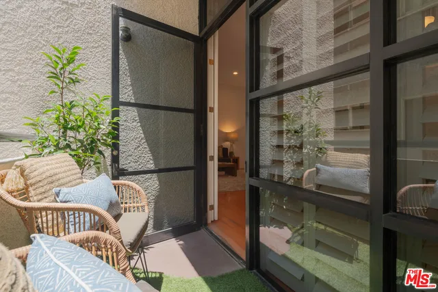 a balcony with a potted plant on a table