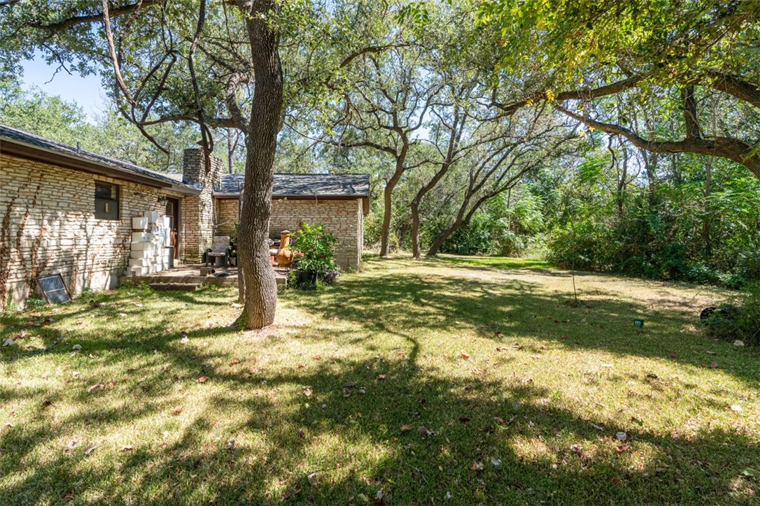8701 Highway 290 Austin, TX 78737 - Photo 4 of 40 a view of a yard with plants and large trees
