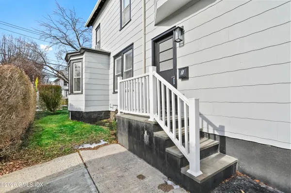 a view of entryway with stairs and wooden floor