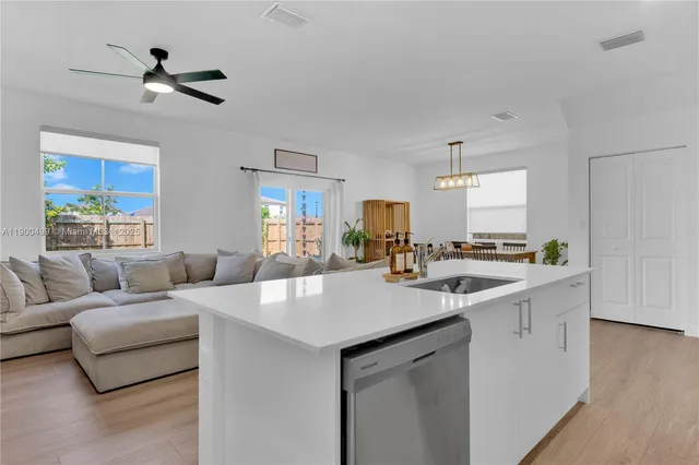 a view of living room with granite countertop furniture and a ceiling fan