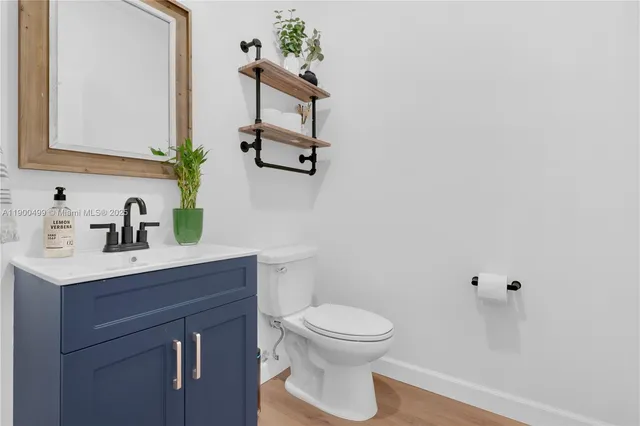 a bathroom with a toilet a sink and mirror