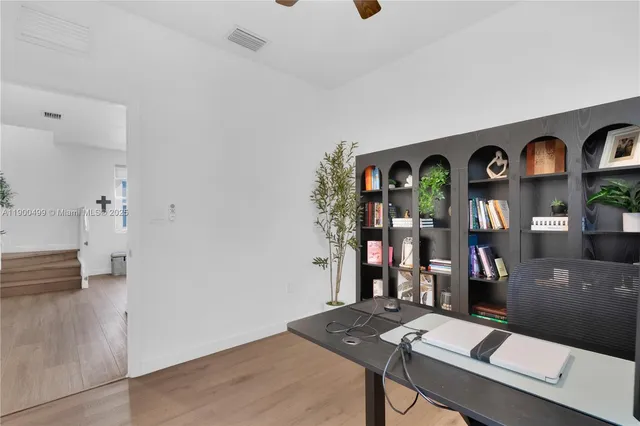a view of hall way with furniture and chandelier