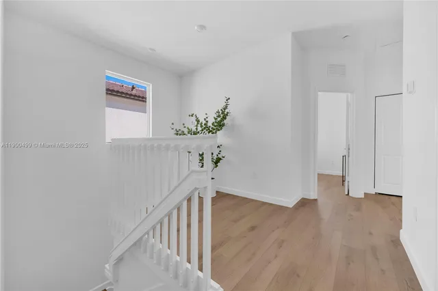 a view of an entryway with wooden floor