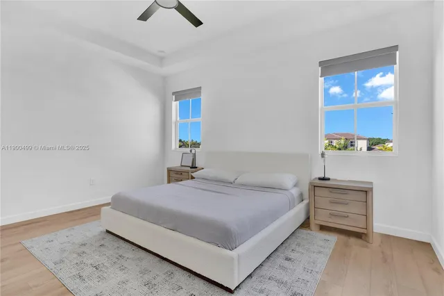 a bedroom with a bed and ceiling fan