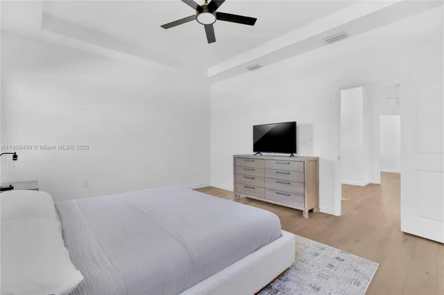 a bedroom with a bed and flat screen tv