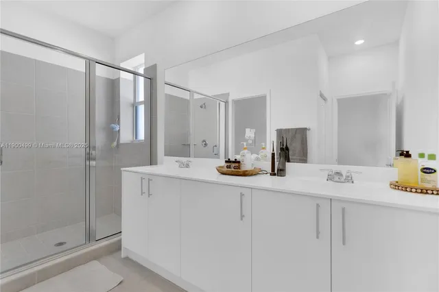 a bathroom with a shower sink vanity and toilet