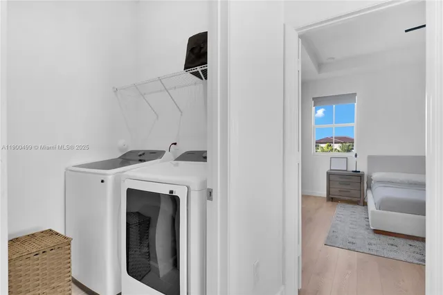 a view of a house with brick walls and a yard with potted plants