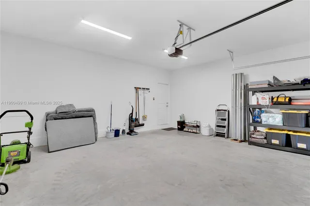 a aerial view of a house with large trees and flower plants
