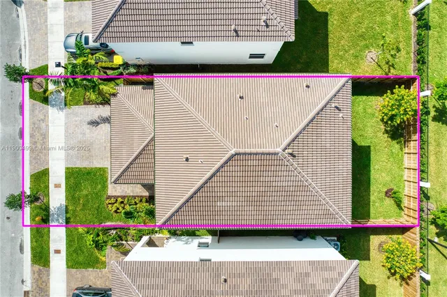 an aerial view of residential houses with outdoor space and street view