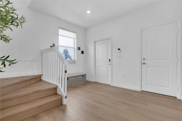 a view of entryway with wooden floor and stairs