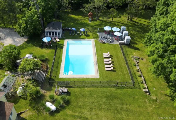 an aerial view of house with yard swimming pool and outdoor seating