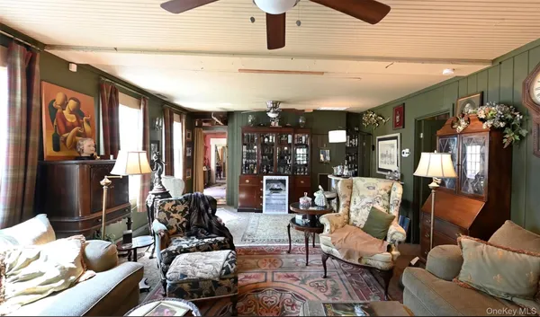 a living room with furniture and flat screen tv