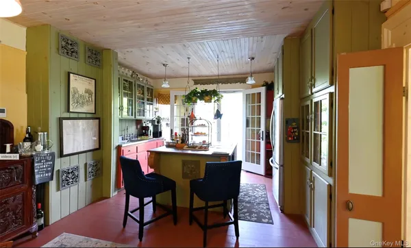 a view of a hallway with wooden floor and chandelier