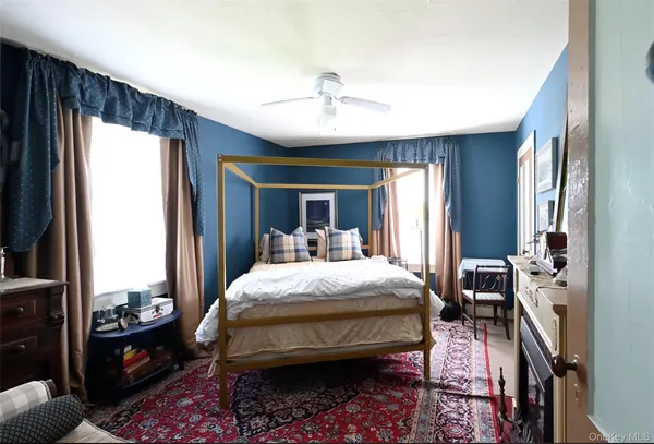 a bedroom with a bed and a night stand