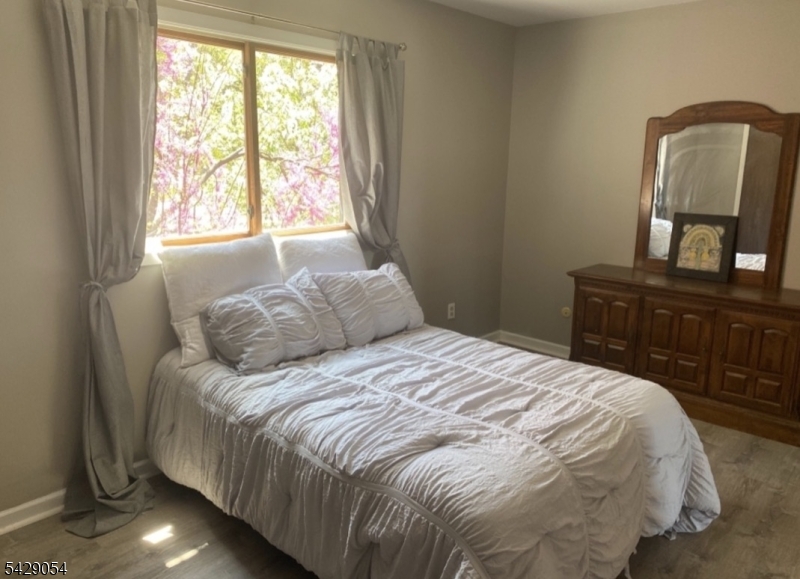 2 Acapulco Princess, Unit 4 Vernon, NJ 07462 - Photo 6 of 8 a bedroom with a bed window and mirror