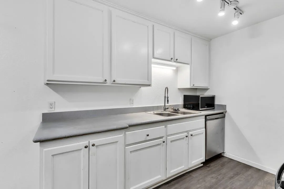 9860 Dale Avenue, Unit A12 Spring Valley, CA 91977 - Photo 13 of 28 a kitchen with stainless steel appliances granite countertop white cabinets and a sink