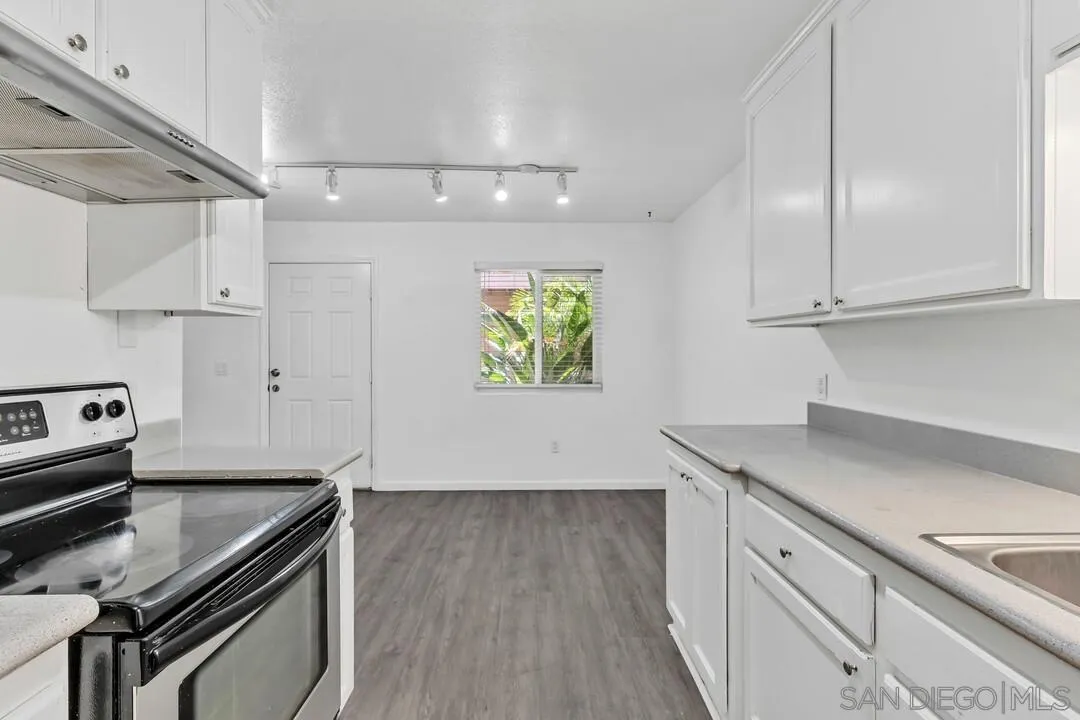9860 Dale Avenue, Unit A12 Spring Valley, CA 91977 - Photo 14 of 28 a kitchen with appliances cabinets and a wooden floor