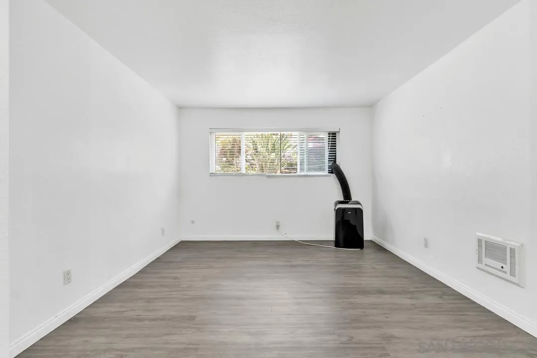 9860 Dale Avenue, Unit A12 Spring Valley, CA 91977 - Photo 16 of 28 an empty room with wooden floor and a window