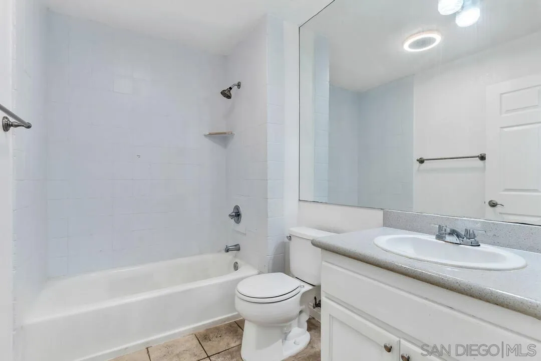 9860 Dale Avenue, Unit A12 Spring Valley, CA 91977 - Photo 22 of 28 a bathroom with a granite countertop sink a toilet and shower