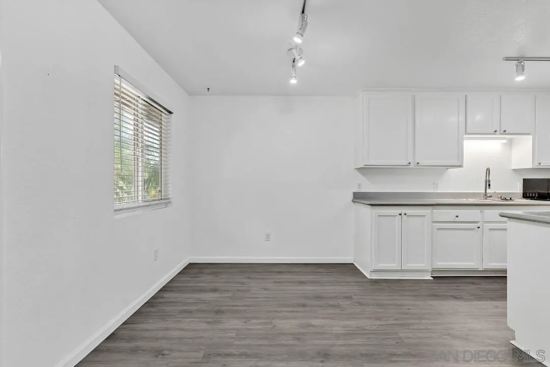 9860 Dale Avenue, Unit A12 Spring Valley, CA 91977 - Photo 10 of 28 a kitchen with granite countertop white cabinets and white appliances