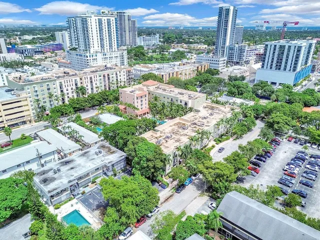 a view of a garden with a deck and furniture