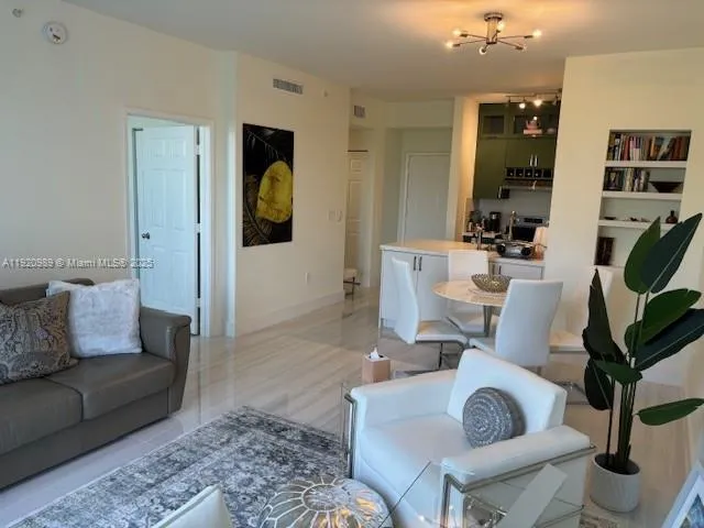 a living room with furniture a rug and a window