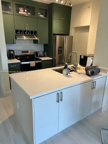 a kitchen with stainless steel appliances a sink and a stove