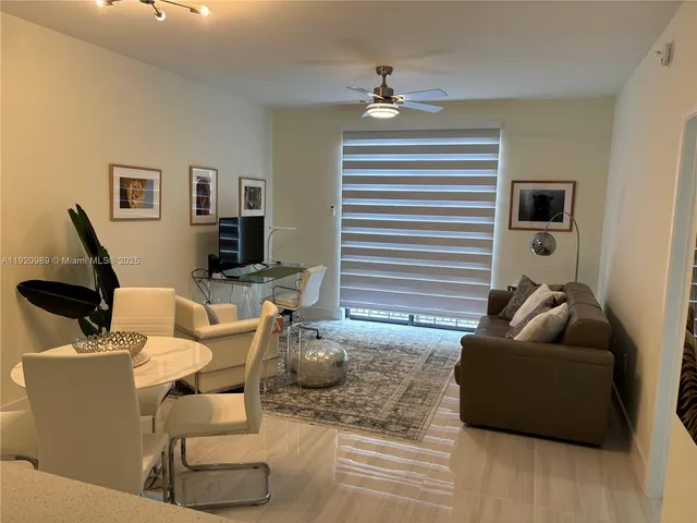 a living room with furniture and a lamp