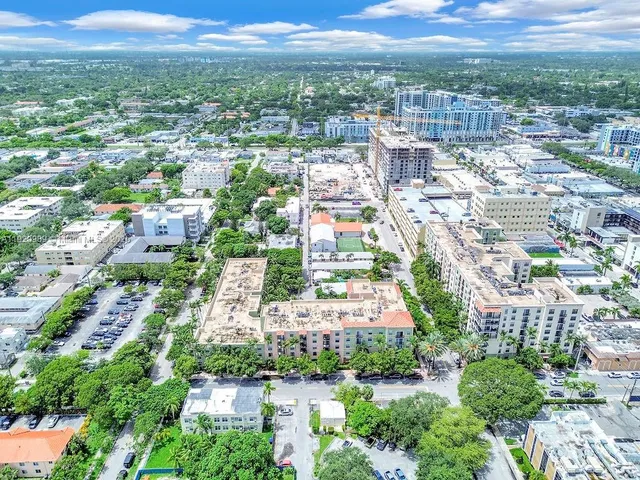 an aerial view of residential houses with city view