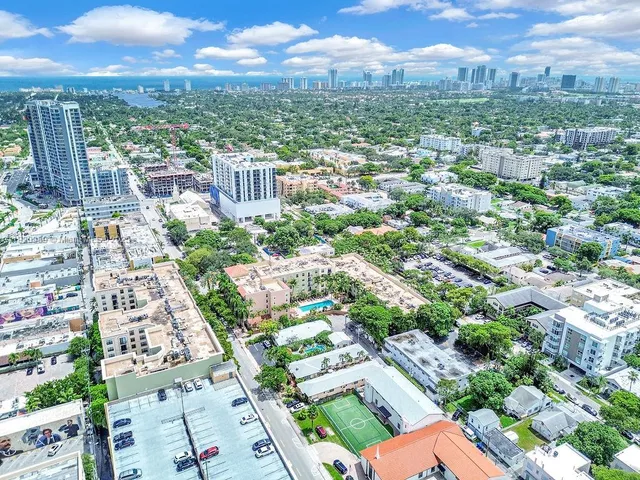 an aerial view of residential houses with city view