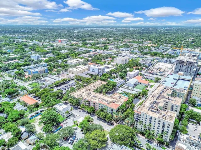an aerial view of residential houses with city view