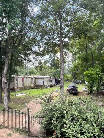 a view of a backyard with a small cabin