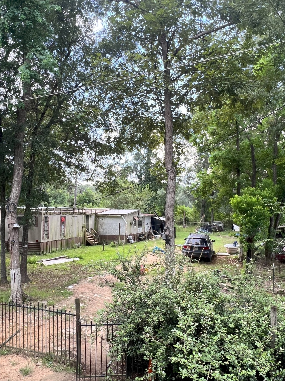 13156 12th Street Splendora, TX 77372 - Photo 4 of 5 a view of a backyard with a small cabin