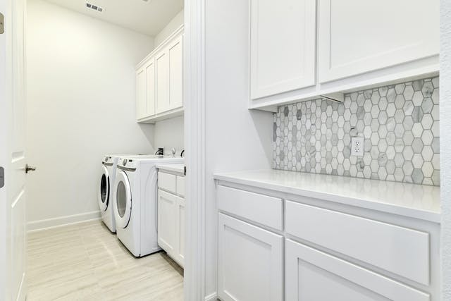 19005 Fernando Trail Austin, TX 78738 - Photo 23 of 26 Laundry room featuring separate washer and dryer and extra cabinet space