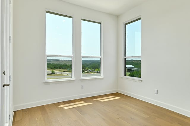 19005 Fernando Trail Austin, TX 78738 - Photo 5 of 26 Dining are opens to the kitchen with large windows and window door to covered patio, very bright, great view