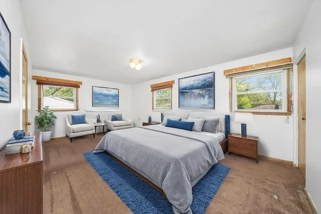 a bedroom with a large bed and a couch