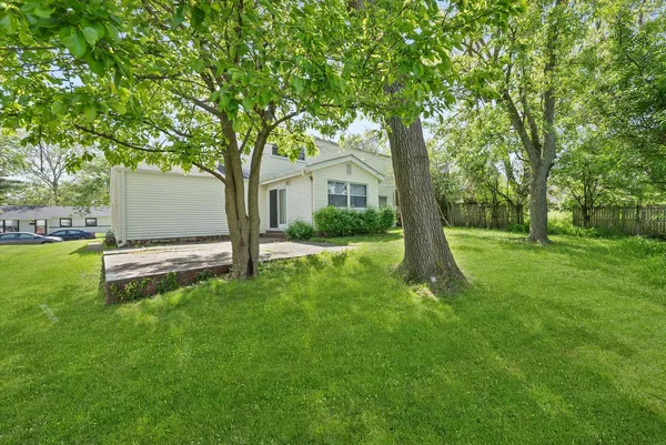 a view of backyard of house with green space